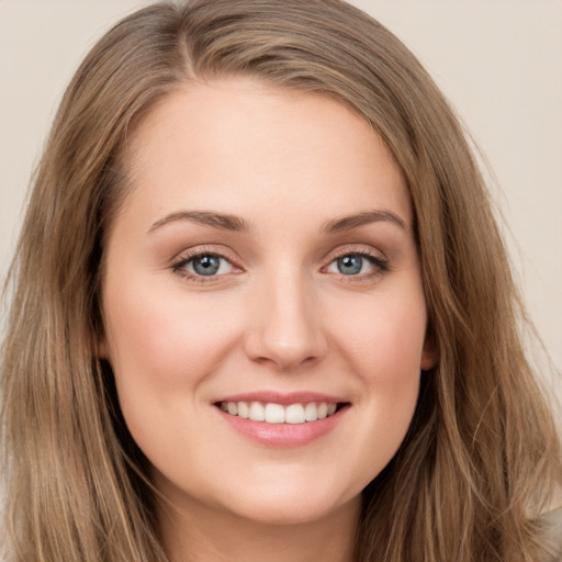 Joyful white young-adult female with long  brown hair and green eyes