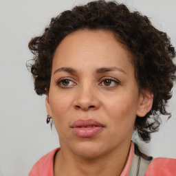 Joyful black adult female with medium  brown hair and brown eyes