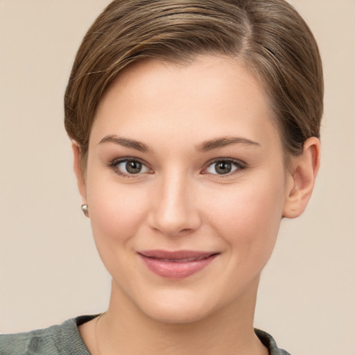 Joyful white young-adult female with short  brown hair and grey eyes