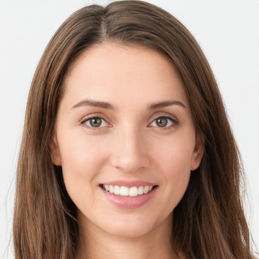 Joyful white young-adult female with long  brown hair and green eyes