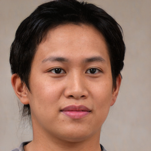 Joyful asian young-adult female with short  brown hair and brown eyes