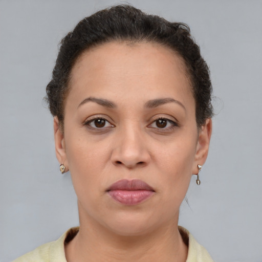 Joyful latino adult female with short  brown hair and brown eyes