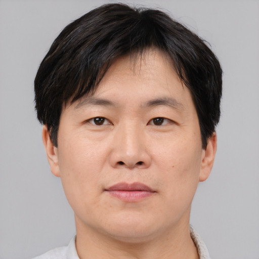 Neutral asian adult male with short  brown hair and brown eyes