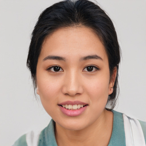 Joyful asian young-adult female with medium  brown hair and brown eyes