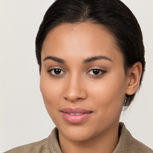 Joyful latino young-adult female with medium  brown hair and brown eyes