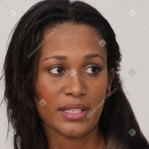 Joyful black young-adult female with long  brown hair and brown eyes