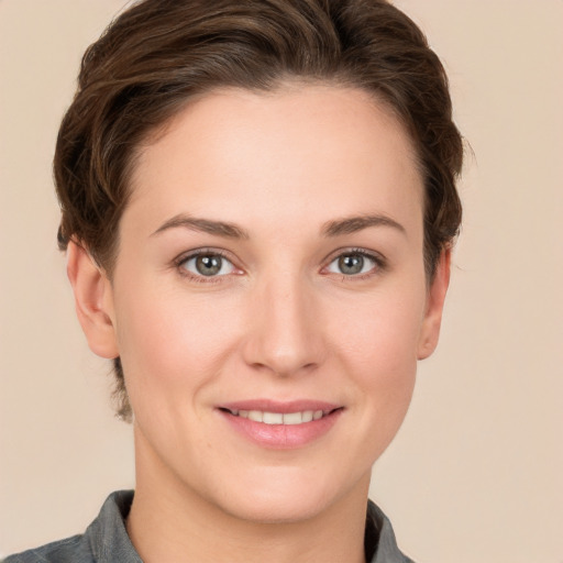 Joyful white young-adult female with short  brown hair and grey eyes