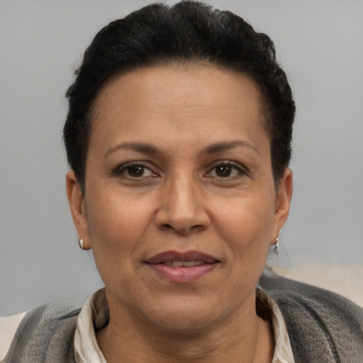 Joyful black adult female with short  brown hair and brown eyes