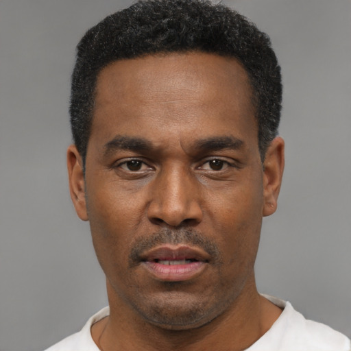 Neutral black young-adult male with short  black hair and brown eyes