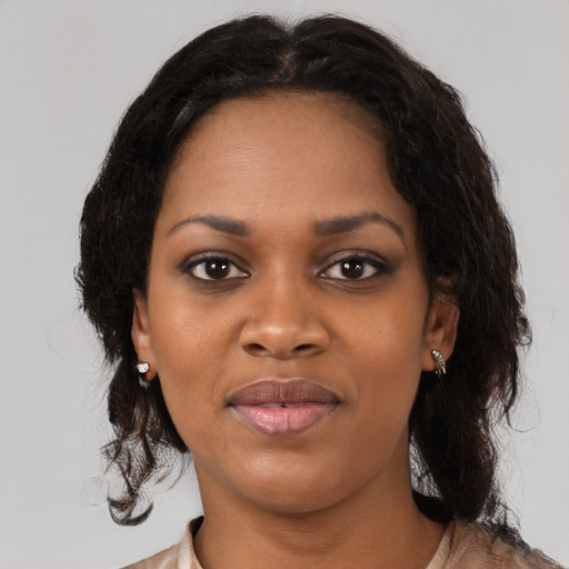 Joyful black young-adult female with medium  brown hair and brown eyes