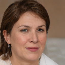 Joyful white adult female with medium  brown hair and brown eyes