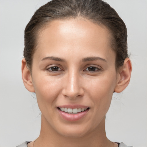 Joyful white young-adult female with medium  brown hair and brown eyes