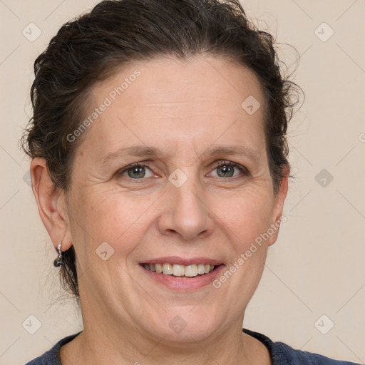 Joyful white adult female with medium  brown hair and grey eyes