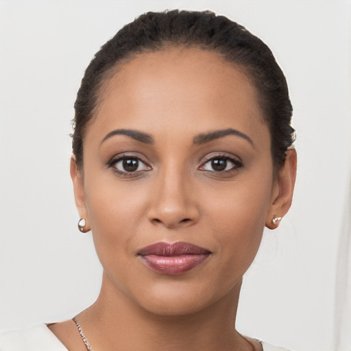 Joyful latino young-adult female with short  brown hair and brown eyes