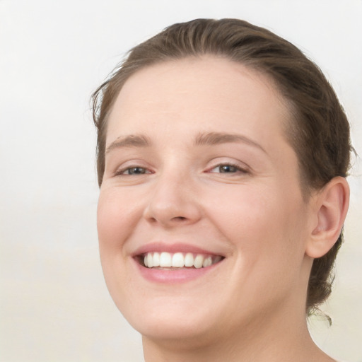 Joyful white young-adult female with long  brown hair and blue eyes