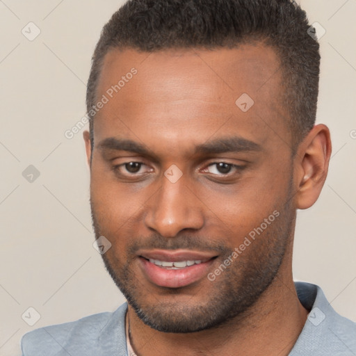 Joyful black young-adult male with short  brown hair and brown eyes