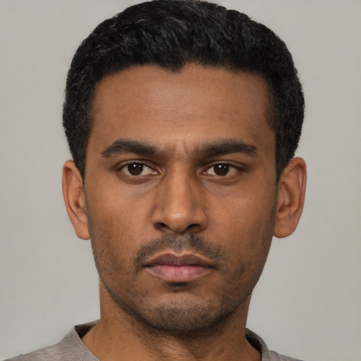 Neutral latino young-adult male with short  black hair and brown eyes