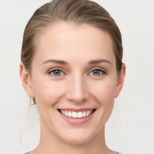 Joyful white young-adult female with medium  brown hair and blue eyes