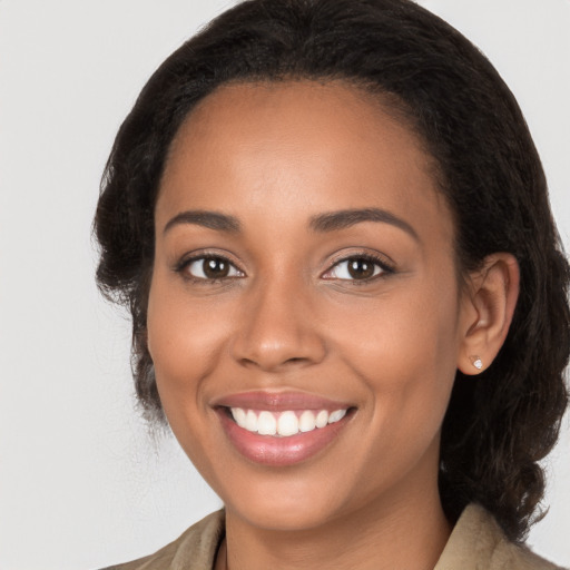 Joyful latino young-adult female with long  brown hair and brown eyes