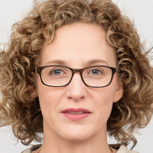 Joyful white adult female with medium  brown hair and blue eyes