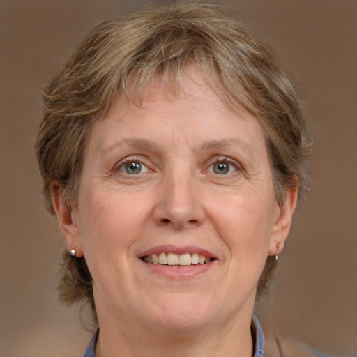 Joyful white middle-aged female with medium  brown hair and grey eyes