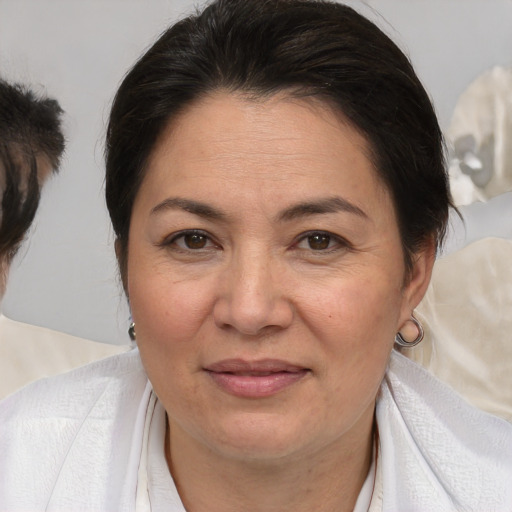 Joyful white adult female with medium  brown hair and brown eyes