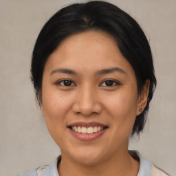 Joyful asian young-adult female with medium  brown hair and brown eyes