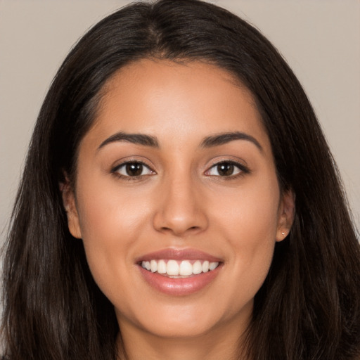 Joyful white young-adult female with long  brown hair and brown eyes