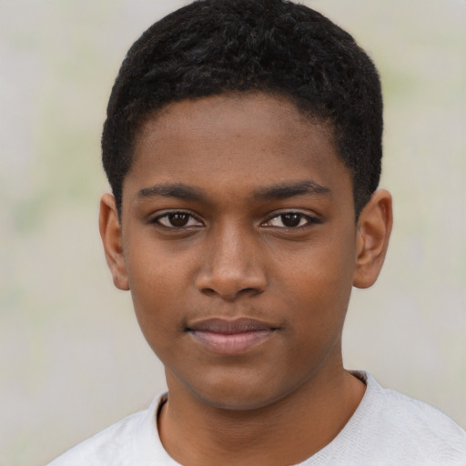 Joyful black child male with short  black hair and brown eyes