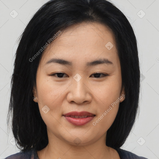 Joyful asian young-adult female with medium  black hair and brown eyes