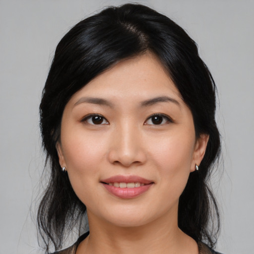 Joyful asian young-adult female with medium  black hair and brown eyes