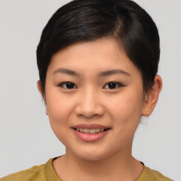 Joyful asian young-adult female with short  brown hair and brown eyes