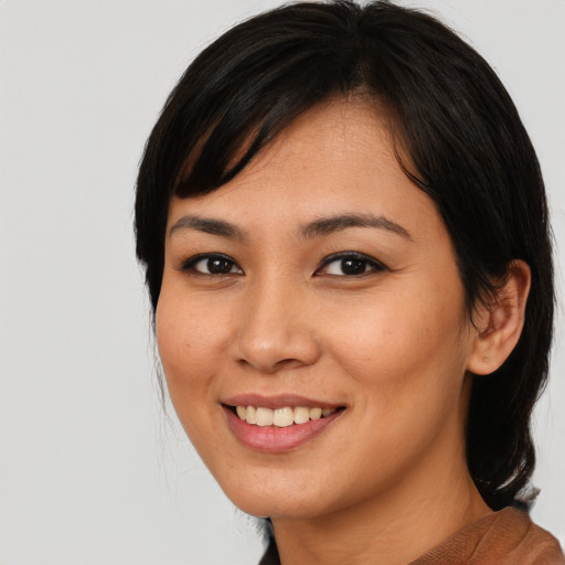 Joyful asian young-adult female with medium  black hair and brown eyes