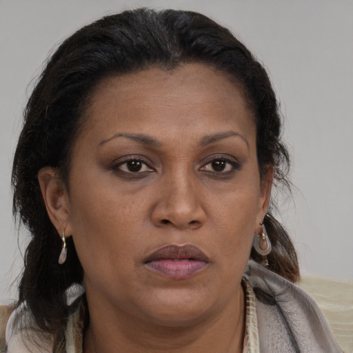 Joyful black adult female with medium  brown hair and brown eyes
