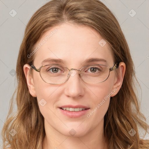 Joyful white adult female with long  brown hair and blue eyes