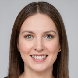 Joyful white young-adult female with long  brown hair and grey eyes