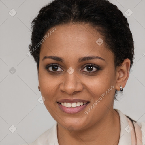 Joyful black young-adult female with short  brown hair and brown eyes