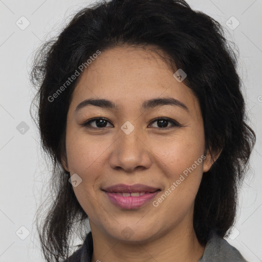 Joyful latino adult female with medium  brown hair and brown eyes