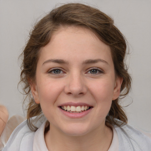 Joyful white young-adult female with medium  brown hair and blue eyes