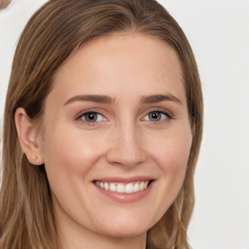 Joyful white young-adult female with long  brown hair and brown eyes