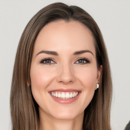 Joyful white young-adult female with long  brown hair and grey eyes