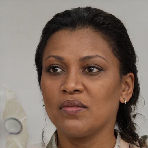 Joyful black young-adult female with medium  brown hair and brown eyes