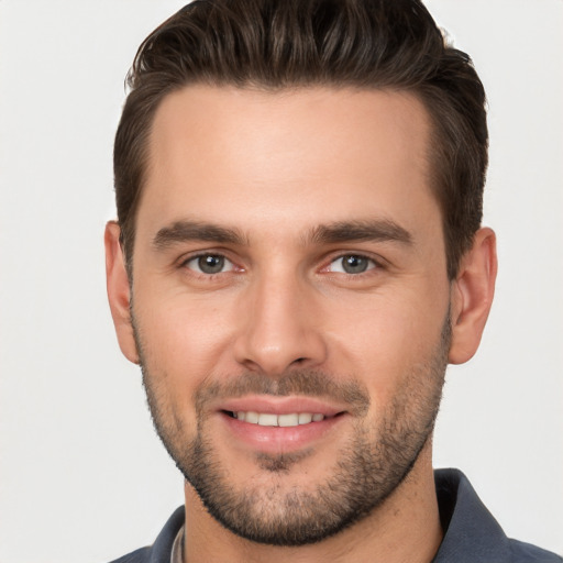 Joyful white young-adult male with short  brown hair and brown eyes