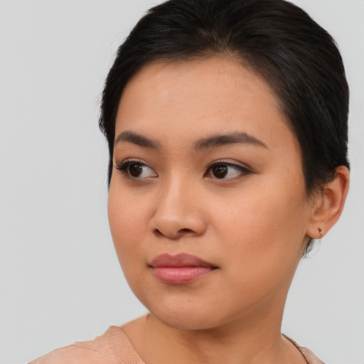 Joyful asian young-adult female with medium  brown hair and brown eyes