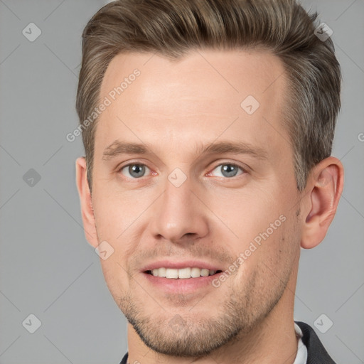 Joyful white young-adult male with short  brown hair and grey eyes