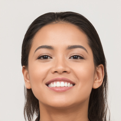 Joyful latino young-adult female with long  black hair and brown eyes