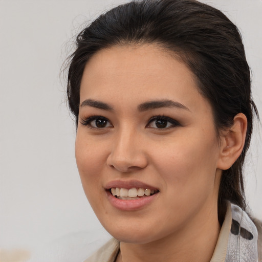 Joyful asian young-adult female with medium  brown hair and brown eyes