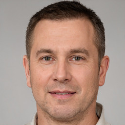 Joyful white adult male with short  brown hair and brown eyes