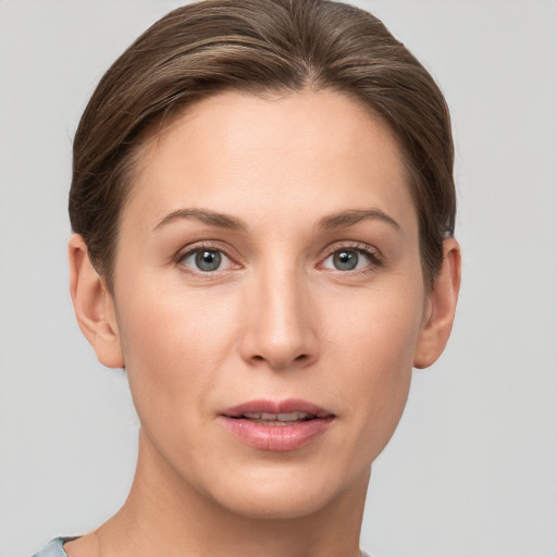 Joyful white young-adult female with short  brown hair and grey eyes