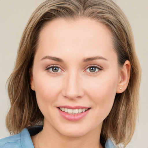 Joyful white young-adult female with medium  brown hair and blue eyes